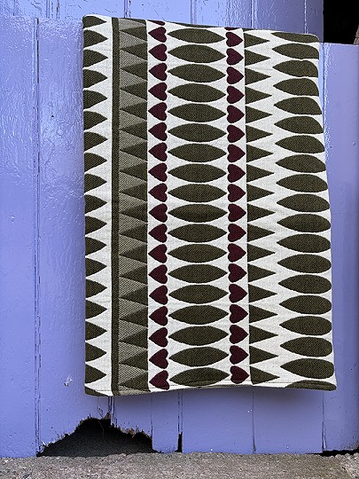 Olive green and burgundy blanket over a purple stable door