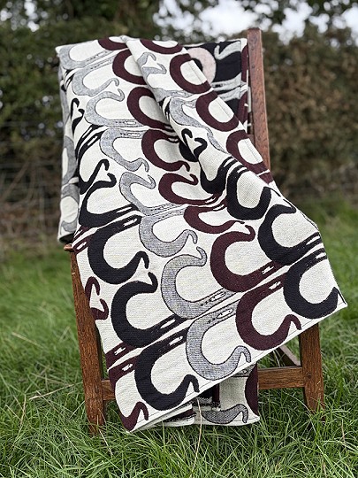 Dark red, black and grey blanket on a chair