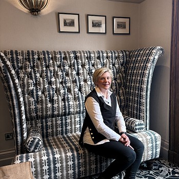 woman sitting on a sofa with a a tall back