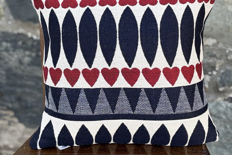 navy and red patterned cushion on a wooden chair